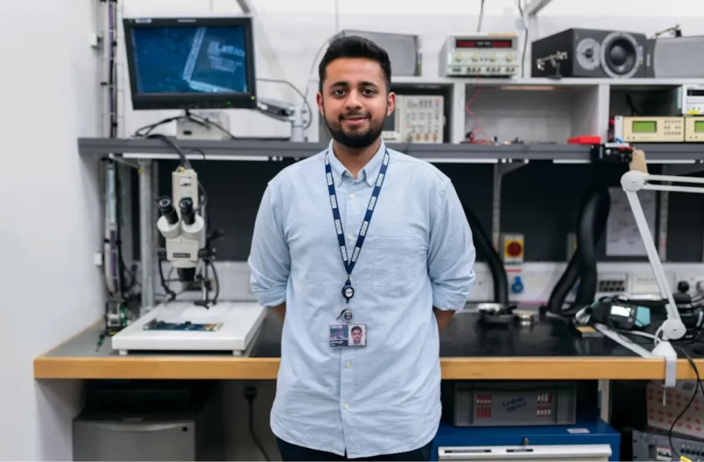 Engineer in a tech lab surrounded by innovative micro technology.