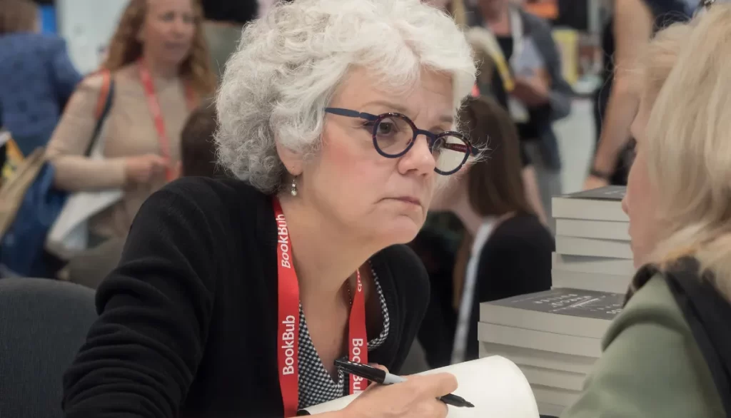 Marcia Butler signing books at a public event.